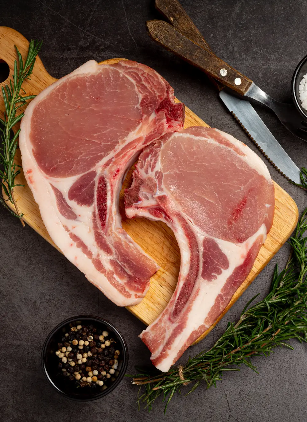 raw-pork-chop-steak-dark-surface-2.webp
